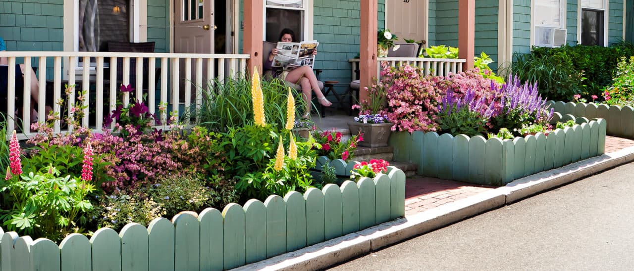 A woman relaxes reading the newspaper on the outdoor patio at the Madison Inn