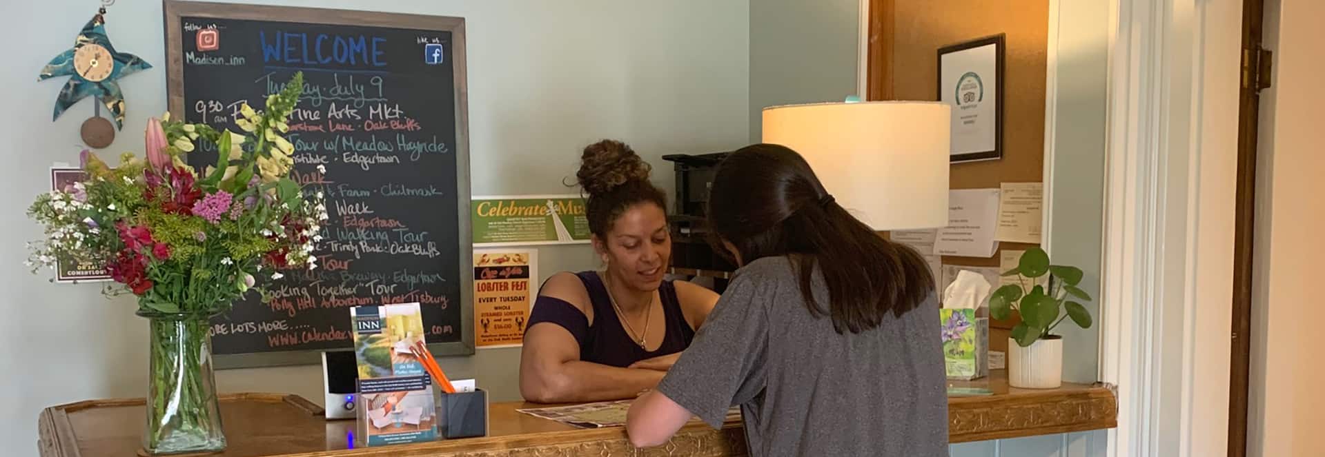 Staff assist a guiest with check in and reccomendations for the Vineyard